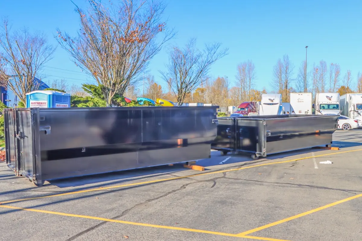 Professional dumpster rental service with roll-off container on residential driveway in Schriever